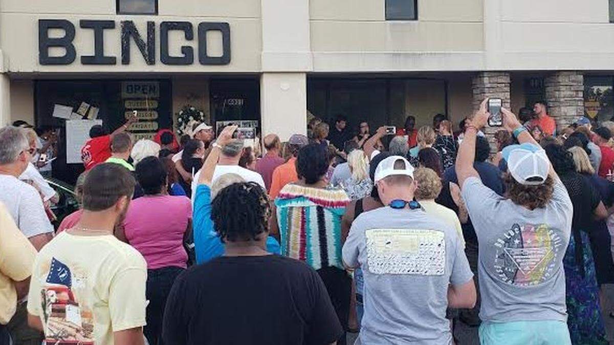 Friends and Family of Steve Johnson Sr. and Steve Johnson Jr attend a candlelight vigil at Waccamaw Bingo on July 29. The two men were shot and killed at the establishment during an attempted robbery on July 26.