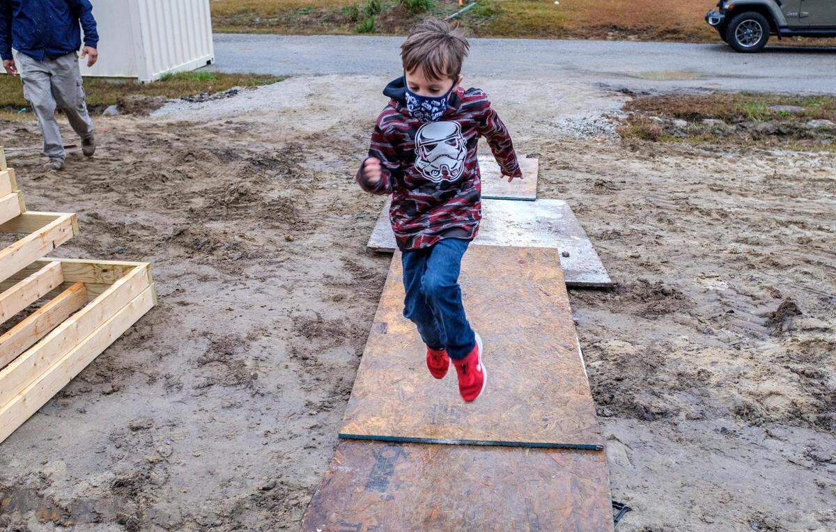 Tanner Ray, age 6, plays in his future drive-way at a ground breaking for the Habitat for Humanity home being built for he and his mother Kimberly Miller. After living much of his life in rental apartments, Miller said her son is most excited about the new drive-way. Miller, and her six-year-old son Tanner, attended a ground breaking of their new Habitat for Humanity home near Conway, S.C. December 16, 2020.