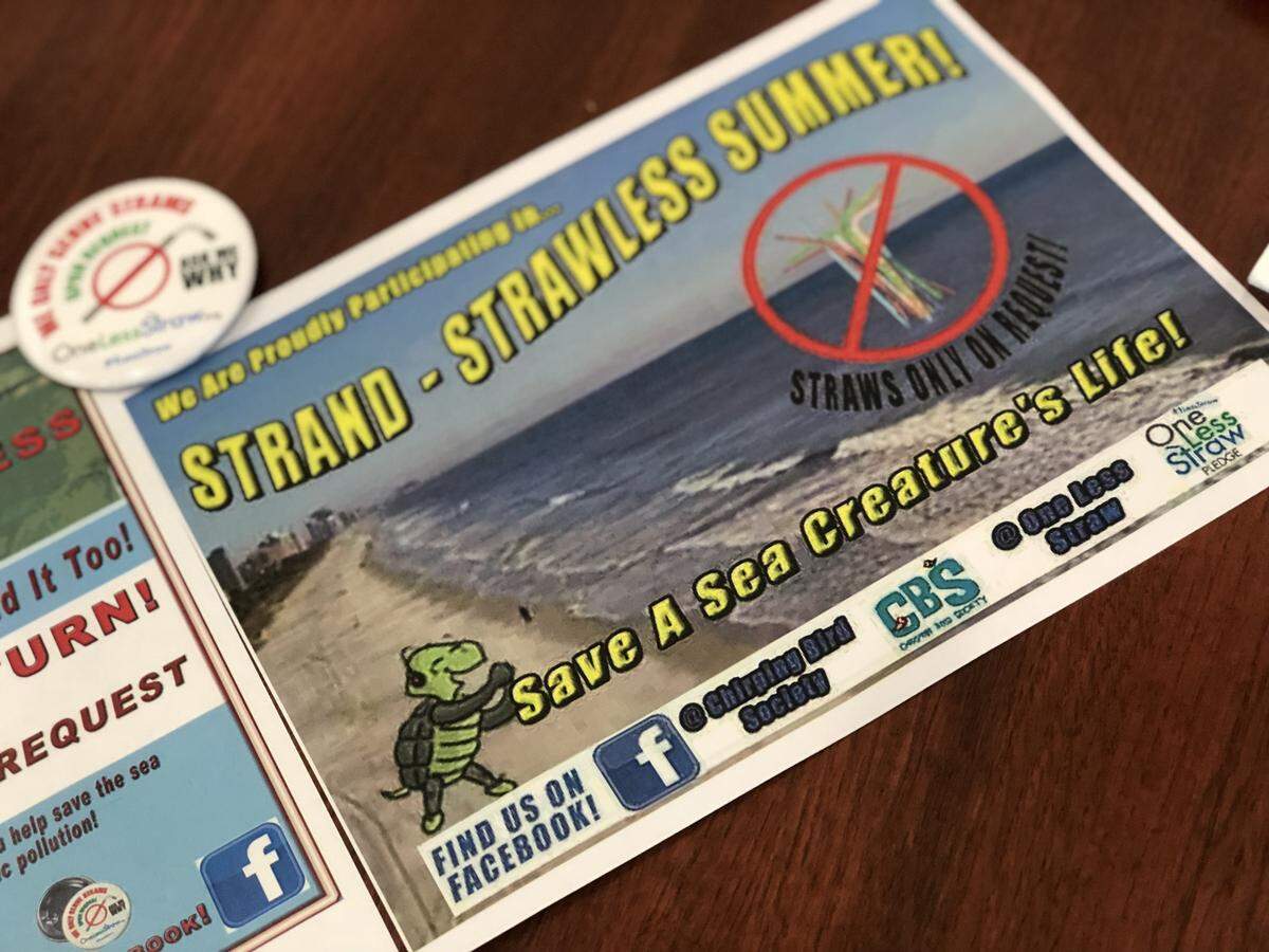 The flyers restaurants hang up to show they are participating in Strand Strawless Summer. June 29, 2018 -
