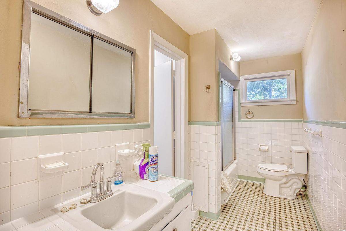 The bathroom is full of tiles, a popular style in the 1950s when the home was built.