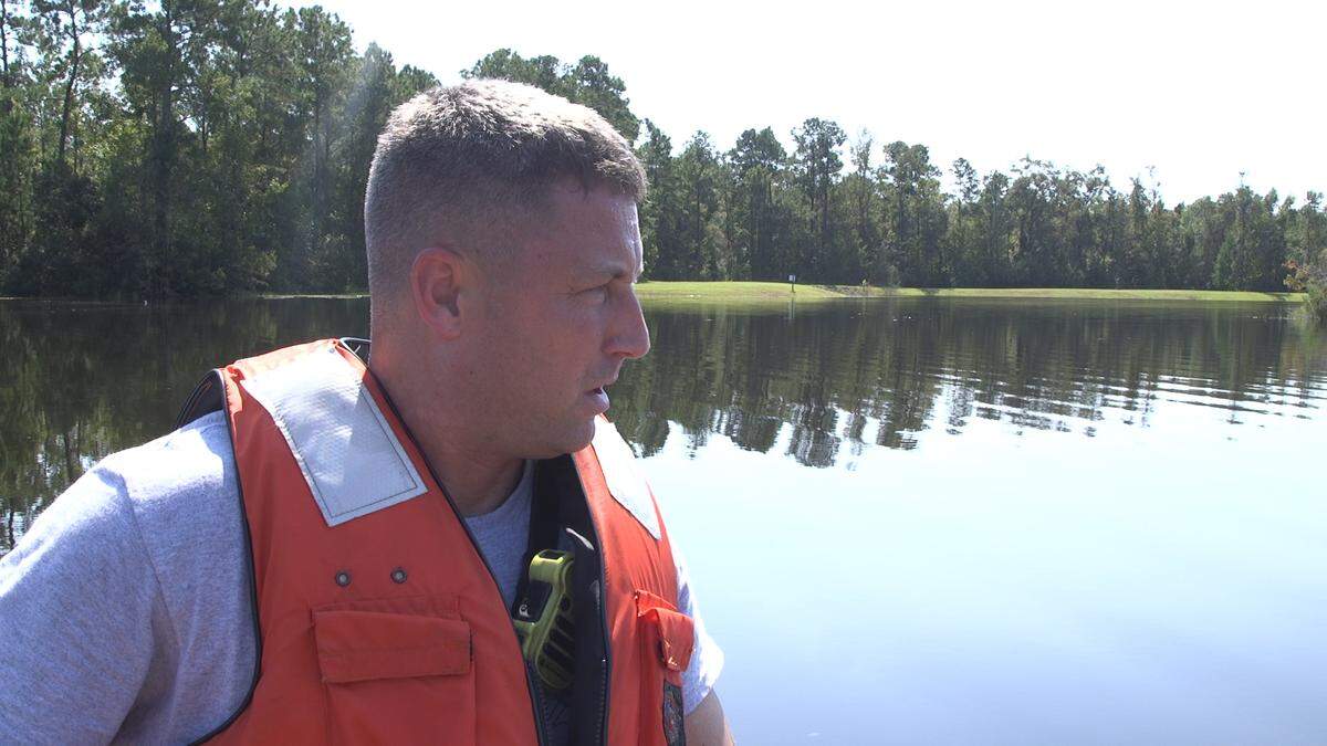 Conway firefighter Jason Perzan works to help people in high waters in the Pecan Groove Subdivision.
