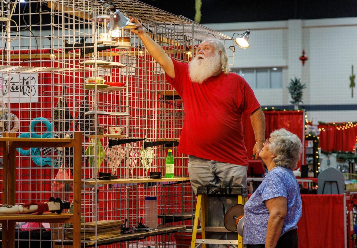 Looking like Santa, Robert Lancaster with InaBeth Lancaster of Leland, NC works on the Duck, Duck, Goose booth at the Dickens Christmas Show. Vendors and staff are decking the halls in preparation for the Dickens Christmas Show at the Myrtle Beach Convention Center. The victorian style holiday event features 350 vendors and begins on Thursday, November 7 through Sunday, November 10, 2024. Tickets are $12 per adult and $5 per child. Nov. 6, 2024.