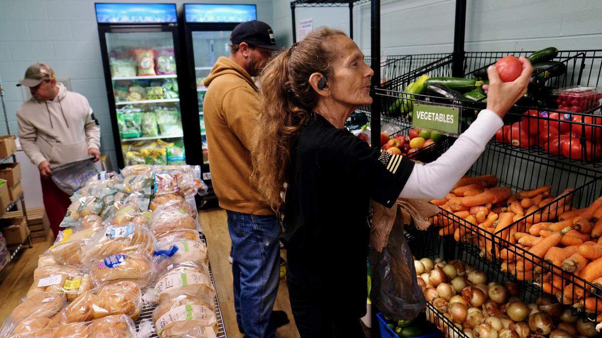 Clients choose food from the pantry at Helping Hand of Myrtle Beach. Executive Director Tracy Gardner says that the non-profit, whose mission it is to “empower families in times of crisis” has been “getting slammed” recently with requests for assistance. “People that have never accessed us are getting registered,” she said.
