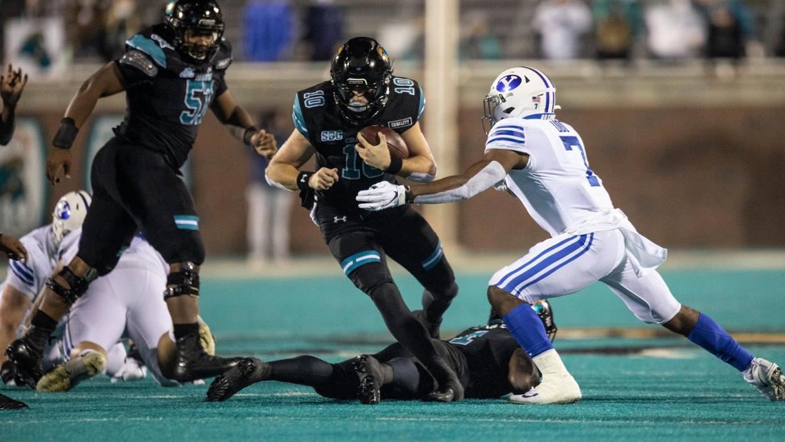 Coastal’s Grayson McCall sneaks through a hole in the BYU defense. Coastal Carolina, ranked #14, won 22-17 over #8 ranked Brigham Young University on Saturday night. Coastal remains undefeated. December 5, 2020.
