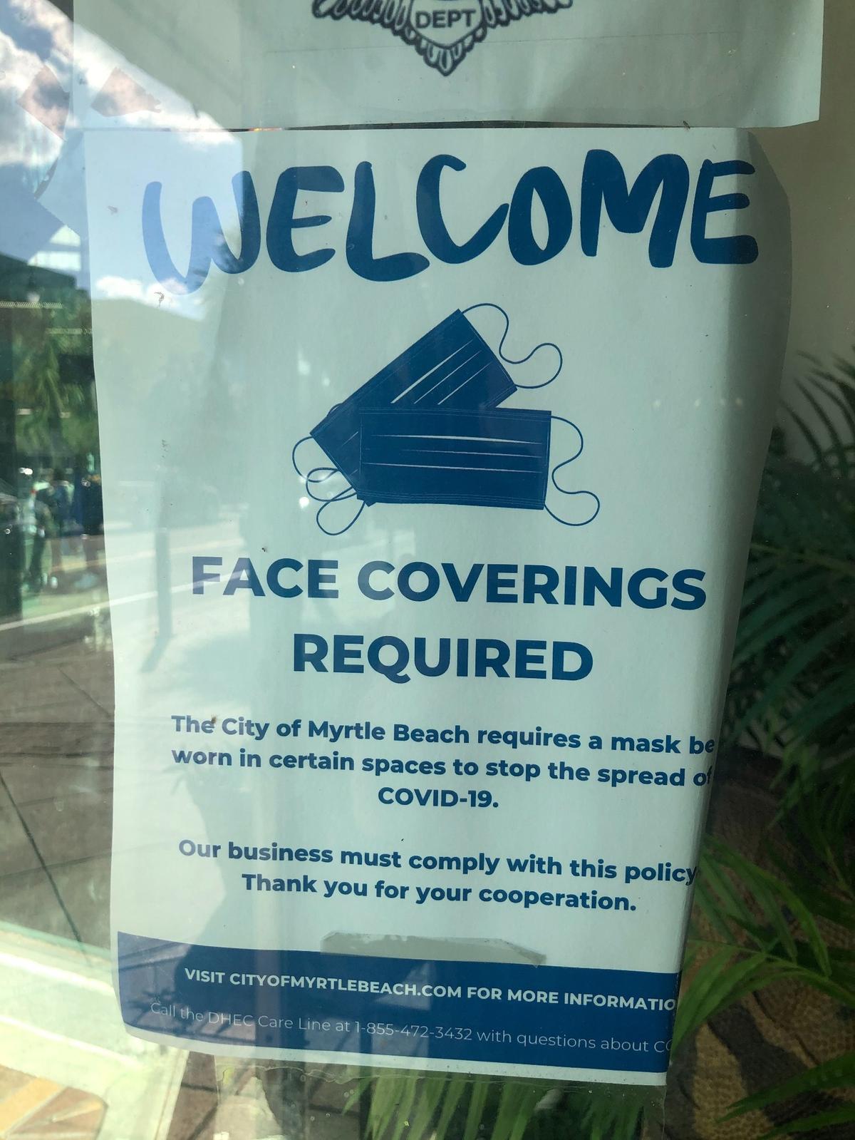 A "face coverings required" sign at at the Gay Dolphin Gift Cove on Ocean Boulevard that remained on the shop's door long after the city of Myrtle Beach ended its mask mandate.
