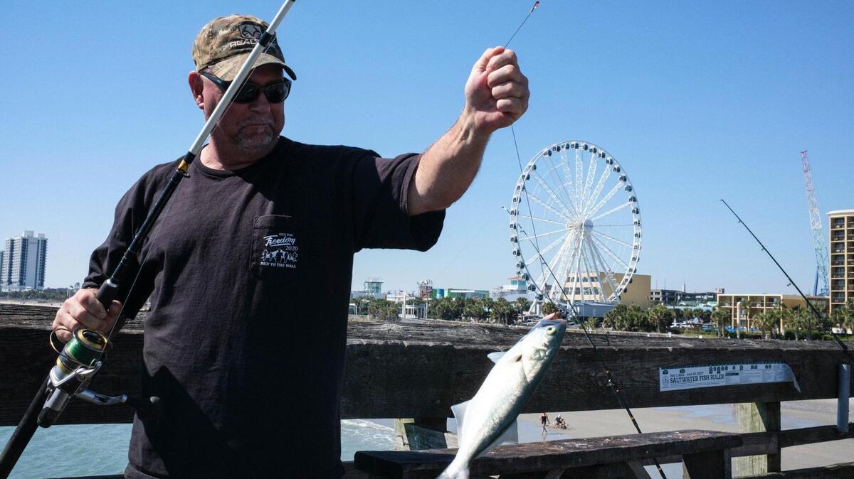 Lenn Ward of Pulaski, Virginia, was among nine friends who make the trip every year in September and October to fish from Pier 14 in Myrtle Beach. Area piers often take a beating from tropical storm systems but a strong pier culture prevails drawing fisherman and tourist back year after year. October 7, 2022.