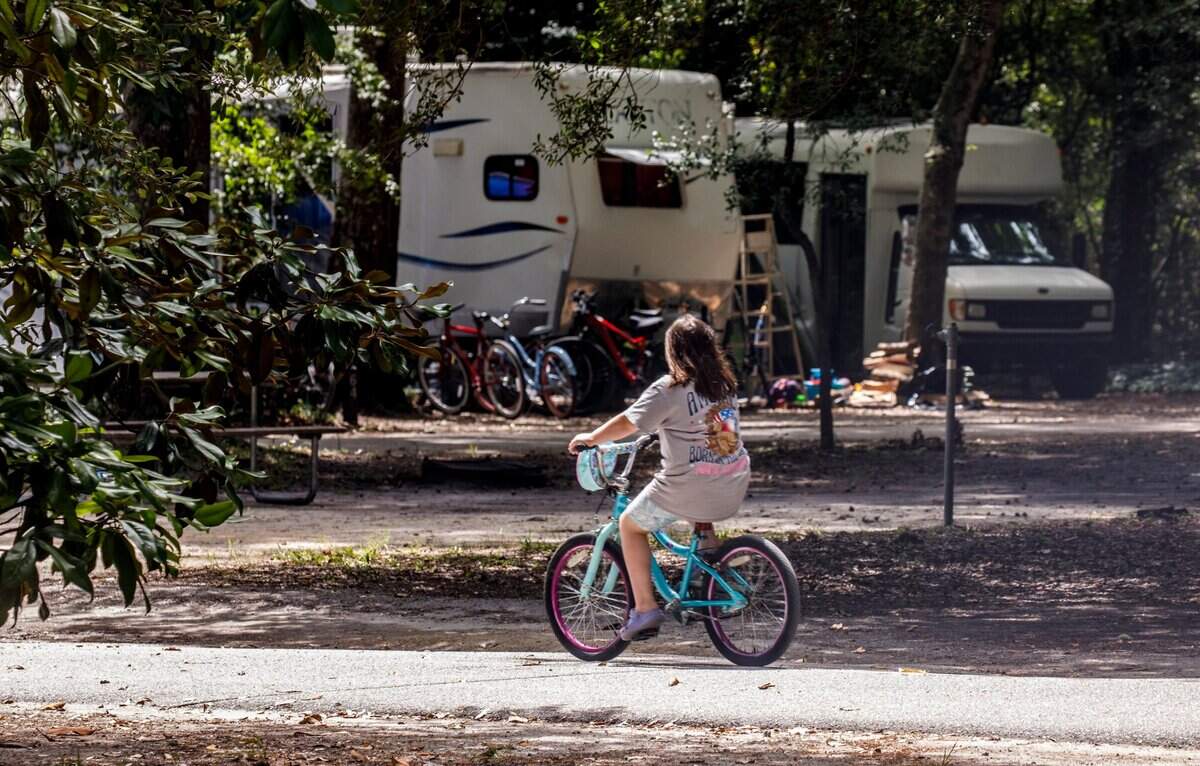 A girl rides her bike through the camp ground at Myrtle Beach State Park. Sept. 4, 2024.