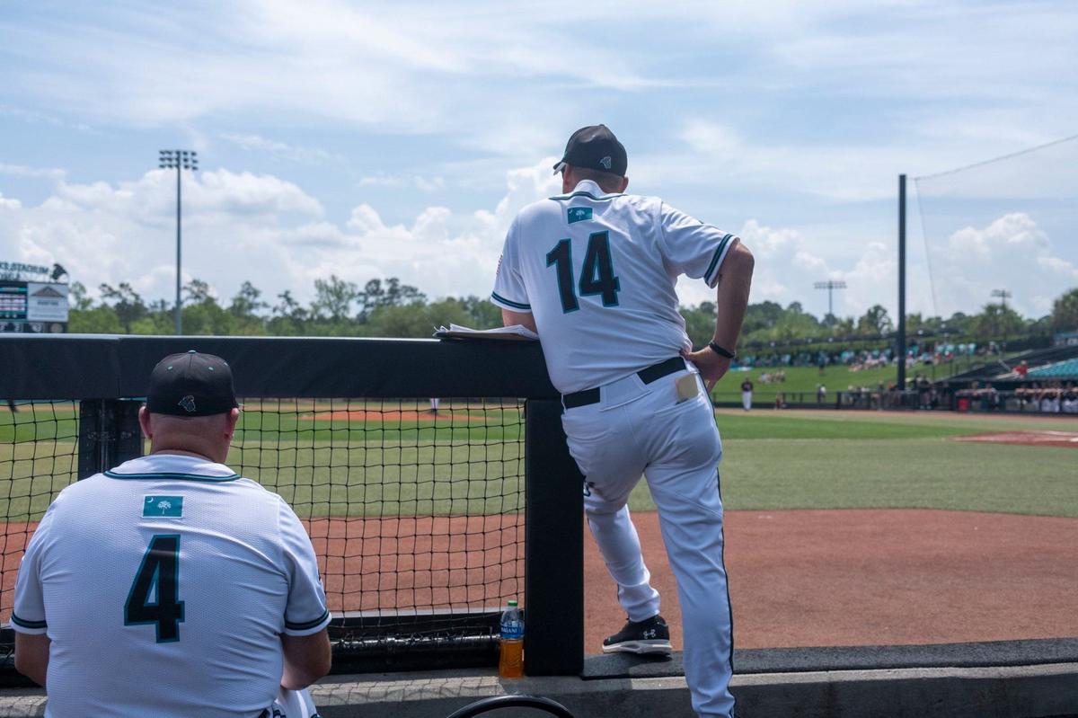 Coastal Carolina Coach Gary Gilmore cheers on his players from his customary place in the dugout at Spring Brooks Stadium. Gilmore is retiring after 39-years of coaching. April 20, 2024.