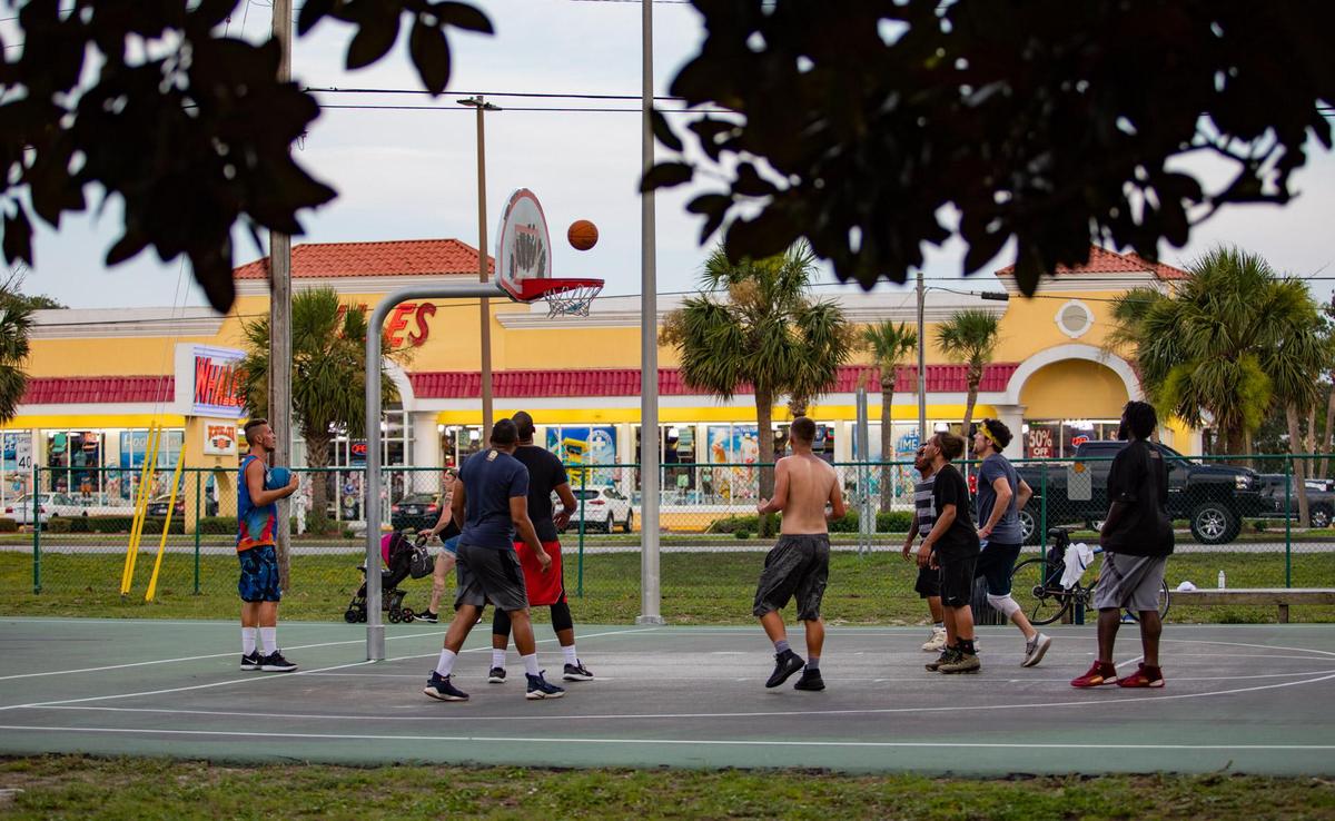 Myrtle Beach residents participate in a game of pick-up basketball on the basketball court at Midway Park in Myrtle Beach Sunday afternoon.