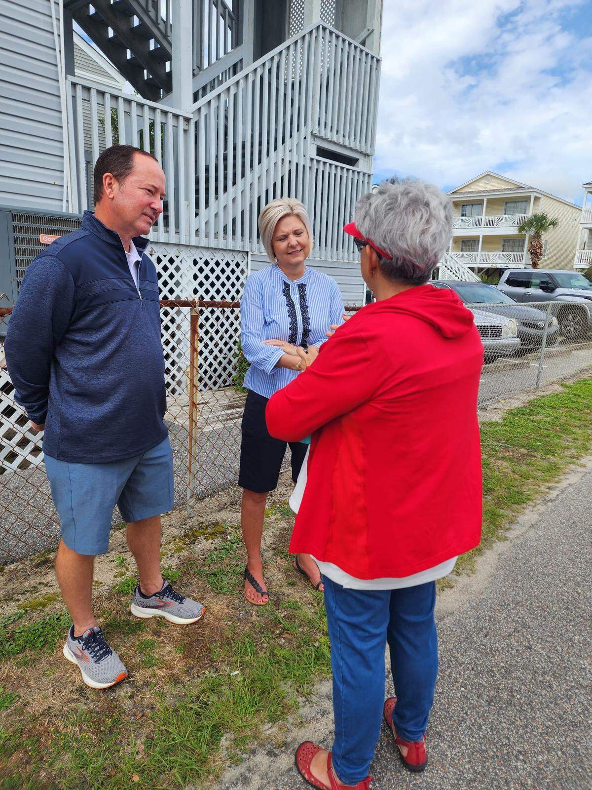 Surfside Beach town administrator Gerry Vincent (left) talks with a pair of town residents.