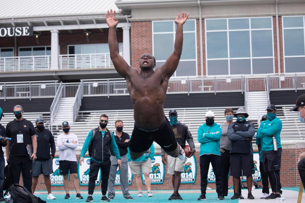 Coastal Carolina’s Tarron Jackson performs a broad jump at the Coastal Carolina Pro Day on Tuesday at Brooks Stadium in Conway, S.C. Jackson, a defensive end who received an invitation to the NFL Combine that is not being held because of the coronavirus, and running back C.J. Marable were among the participants. March 23, 2021.