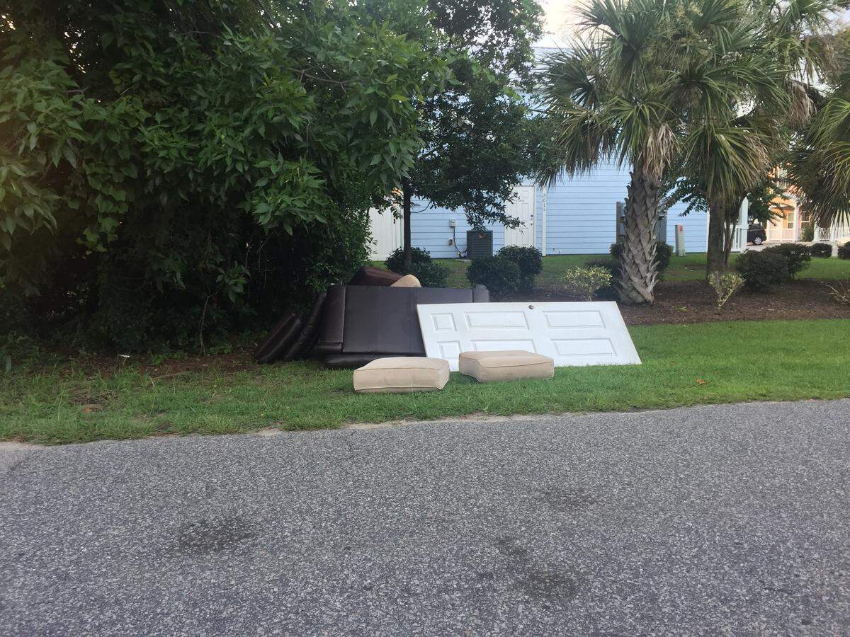 A door sits on top of a pile on garbage on Yaupon Drive between 20th Avenue South and 19th Avenue South.