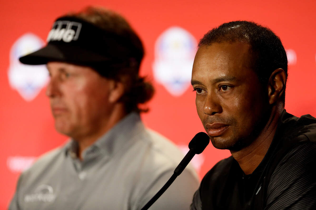 Tiger Woods, right, speaks with Phil Mickelson during a news conference where they were announced as a captain’s pick to the 2018 U.S. Ryder Cup Team, Tuesday, Sept. 4, 2018, in West Conshohocken, Pa.