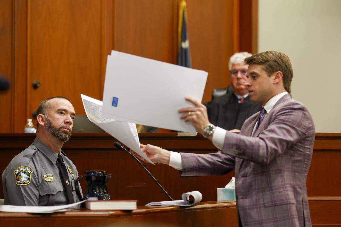 O’Bryan Martin, attorney for Bradley Williams, shows pictures to Horry County Police officer Kerry Higgs during his testimony on Wednesday. A Stand Your Ground hearing is being held this week for Weldon Boyd, owner of Buoys on the Boulevard, and Kenneth “Bradley” Williams in the shooting death of Scott Spivey. Boyd and Williams have been named in a wrongful death lawsuit by the Spivey family in his shooting death nearly three years ago. The hearing will determine if the the pair are granted immunity under South Carolina’s Stand Your Ground law. Feb. 18, 2026.
