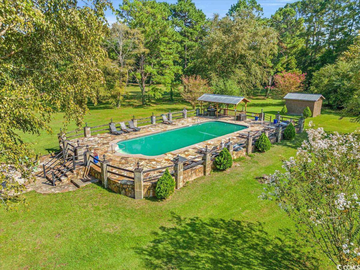 The pool which is located next to the main house. It has a stylish stone exterior, space to sunbathe and a shaded area for those who need to get away from the sun.