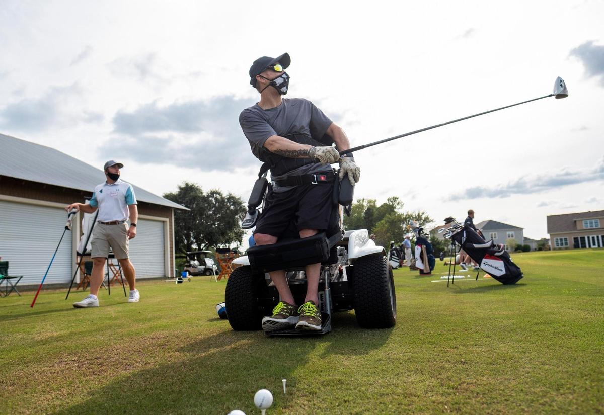 Thomas Maneely, a U.S. Marine Veteran who’s paralyzed takes tee shots from a ParaGolfer all-terrain wheelchair during during the first PGA Hope session at Project Golf at Barefoot Resort. Project Golf, a non-profit initiative by the Golf Tourism Solutions technology and marketing agency, has begun programs at its facility at Barefoot Resort. PGA Hope, a free program for veterans designed to give them an opportunity to learn the game of golf in a fun and healthy environment started at the facility on Tuesday. September 15, 2020.