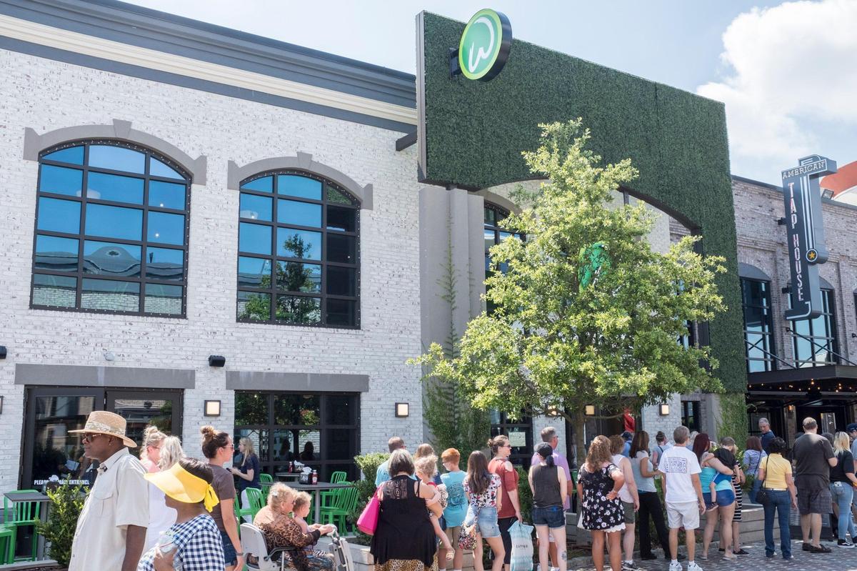 A line of people wait outside Wahlburgers in Myrtle Beach where Chef Paul Wahlberg visited on Tuesday. May 21, 2019.