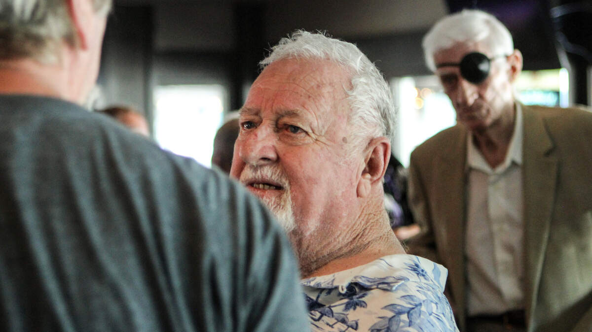 Captain "Poo" McLauchlin talks with friends in Filet's Restaurant Saturday afternoon after the dedication of the newly renamed Captain Archie Neil 'Poo' McLauchlin Swing Brdige in Little River.