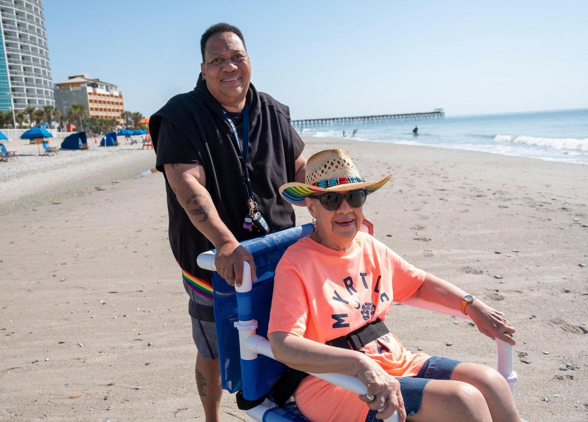 Unita Knight takes her mother, 90-year-old Joan Pulliam, to their favorite beach access in wheelchair to have her their portraits made. Knight purchased the specialized chair for almost $1,000 to be able to take her mother to the beach after the City of Myrtle Beach discontinued providing beach wheelchairs.April 19, 2023.