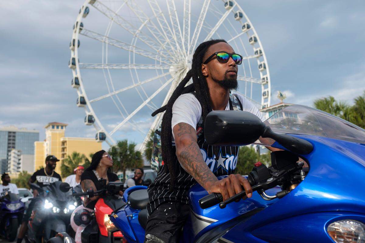 Bikers ride past the Myrtle Beach Skywheel on Ocean Boulevard on Saturday. On boats, beaches and the boulevards, tourists and residents enjoy the first days of the summer season on the Grand Strand during Memorial Day weekend 2021. May 29, 2021.