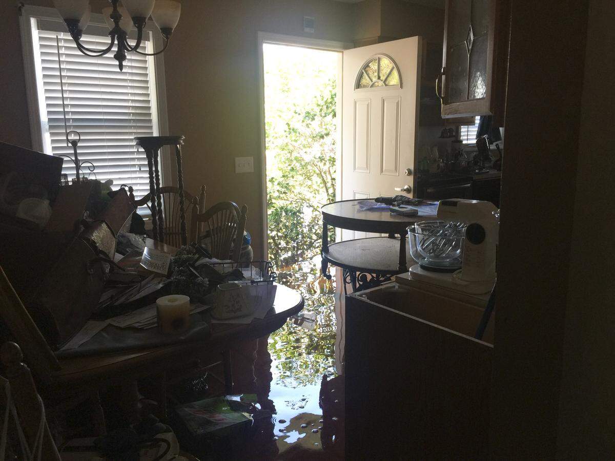 Six-inch-deep water flows through Jay and Cessa Davis’s home on Sept. 23, 2018.