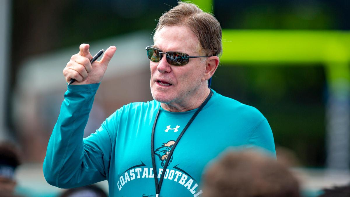 Coastal Carolina head football coach Joe Moglia talks to players after a scrimmage during the preseason at Brooks Stadium in Conway.