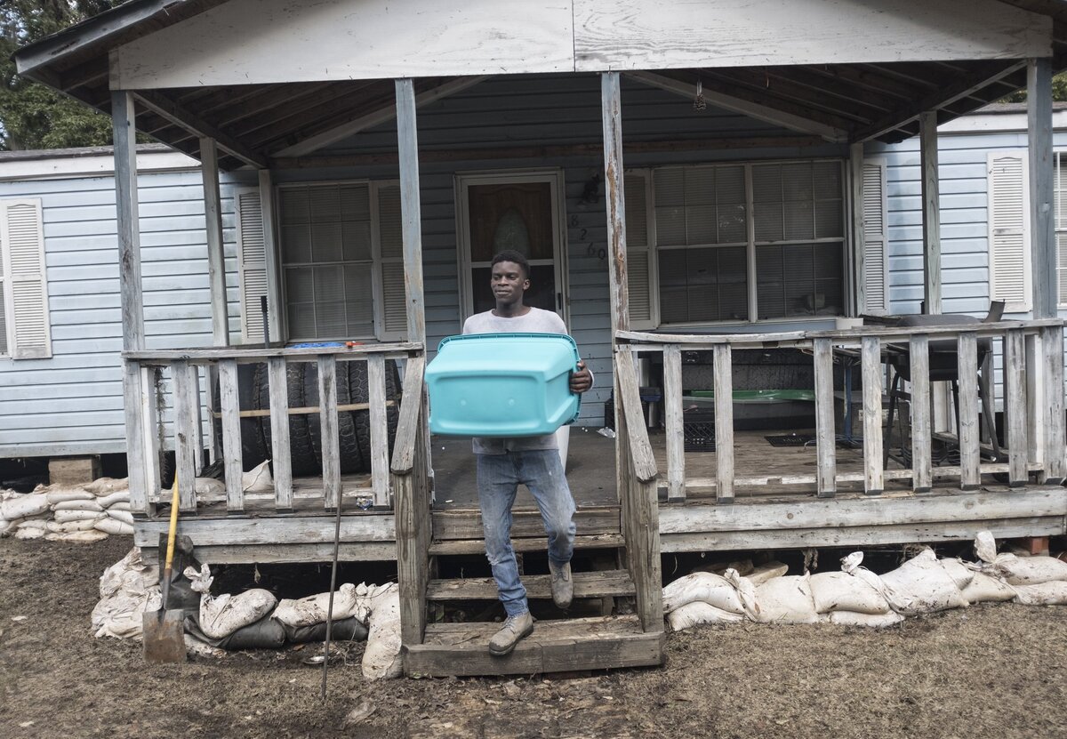 Blake McCray collects family pictures from his flooded home off Martin Luther Rd. in Bucksport trying to prevent important memories from being spoiled by the moisture. Flooding along Bucksport Road finally receded enough on Wednesday for residents to get a first look at their flooded homes. Wednesday. October 3, 2018.