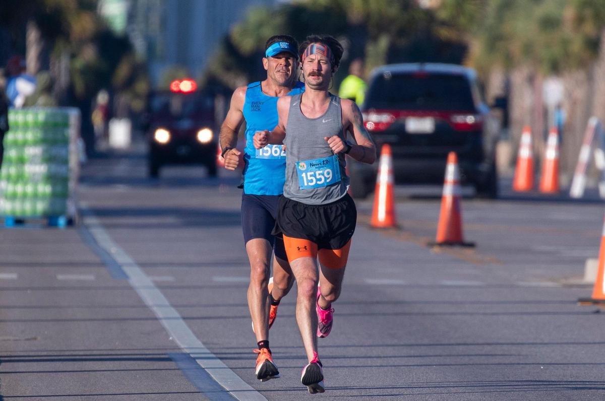 The 24th Myrtle Beach Marathon started Saturday morning featuring approximately 4,000 runners in full marathon, half marathon and 5-kilometer races. Ken Rideout of Nashville, Tn in blue was in second place at the 11 mile mark behind William Moore but ultimately won his first full marathon with a time of 2:20:57. May 1, 2021.