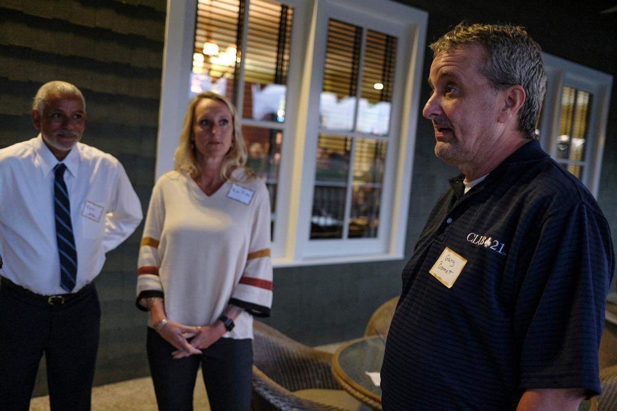 Gary Bennet (right) a former homeless Navy veteran talks about how the partnership between Project Golf and the Eastern Carolina Homelessness Organization (ECHO) has helped recovery his life as ECHO Housing Director Kim Pike and fellow veteran Mark Jacobs listen. Dec. 7, 2021.