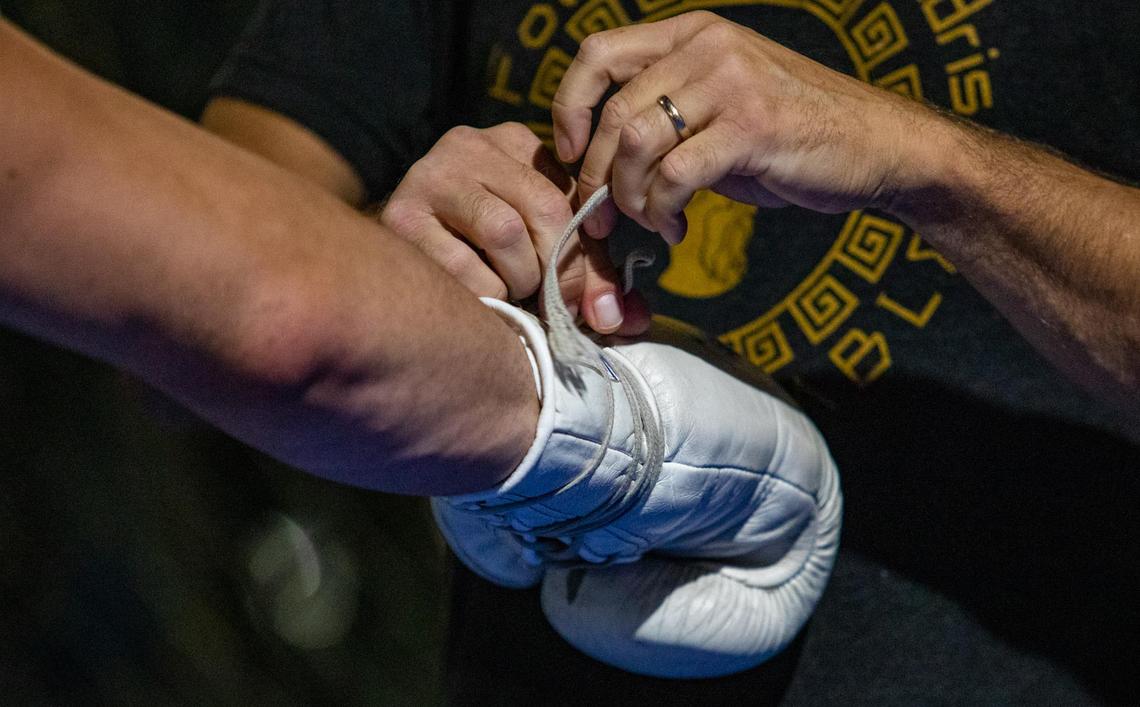 Trainer Chris Goude wraps MMA fighter Joe Solecki’s hands before beginning training Tuesday afternoon at Fitness Edge in Conway.