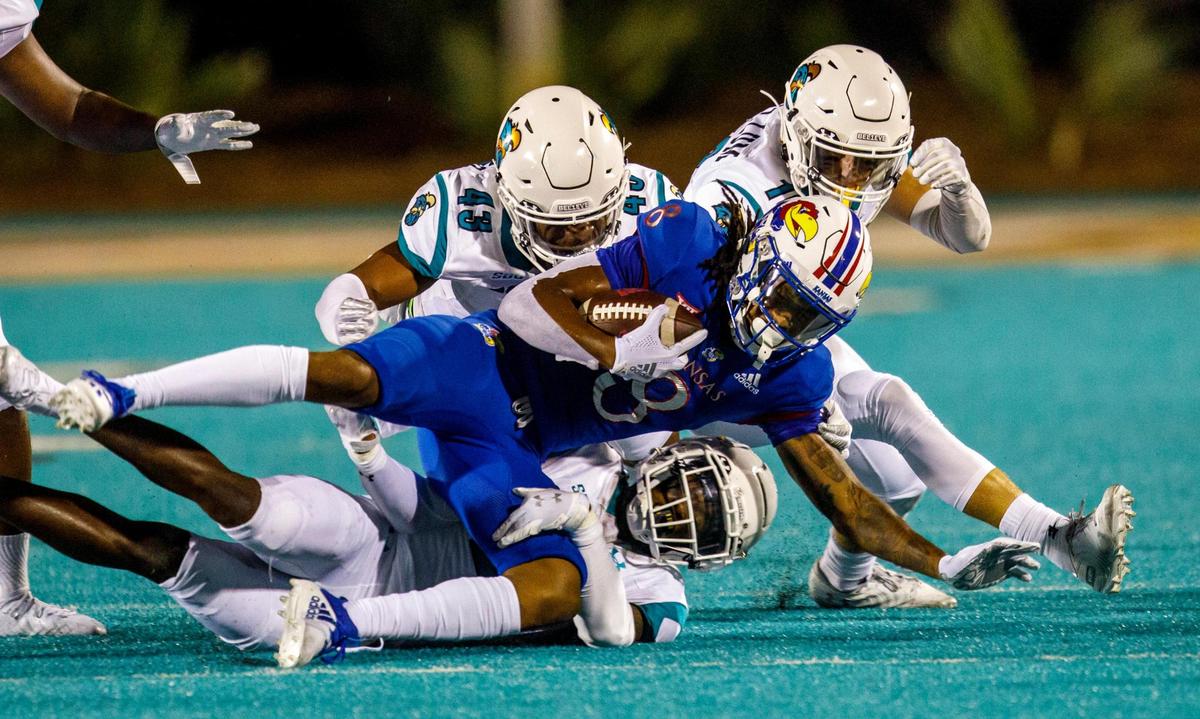 Coastal’s defense brings down Kansas wide receiver Kwamie Lassiter II. The Coastal Carolina Chanticleers hosted Kansas at Brooks Stadium on Friday night, Aug. 11, 2021.