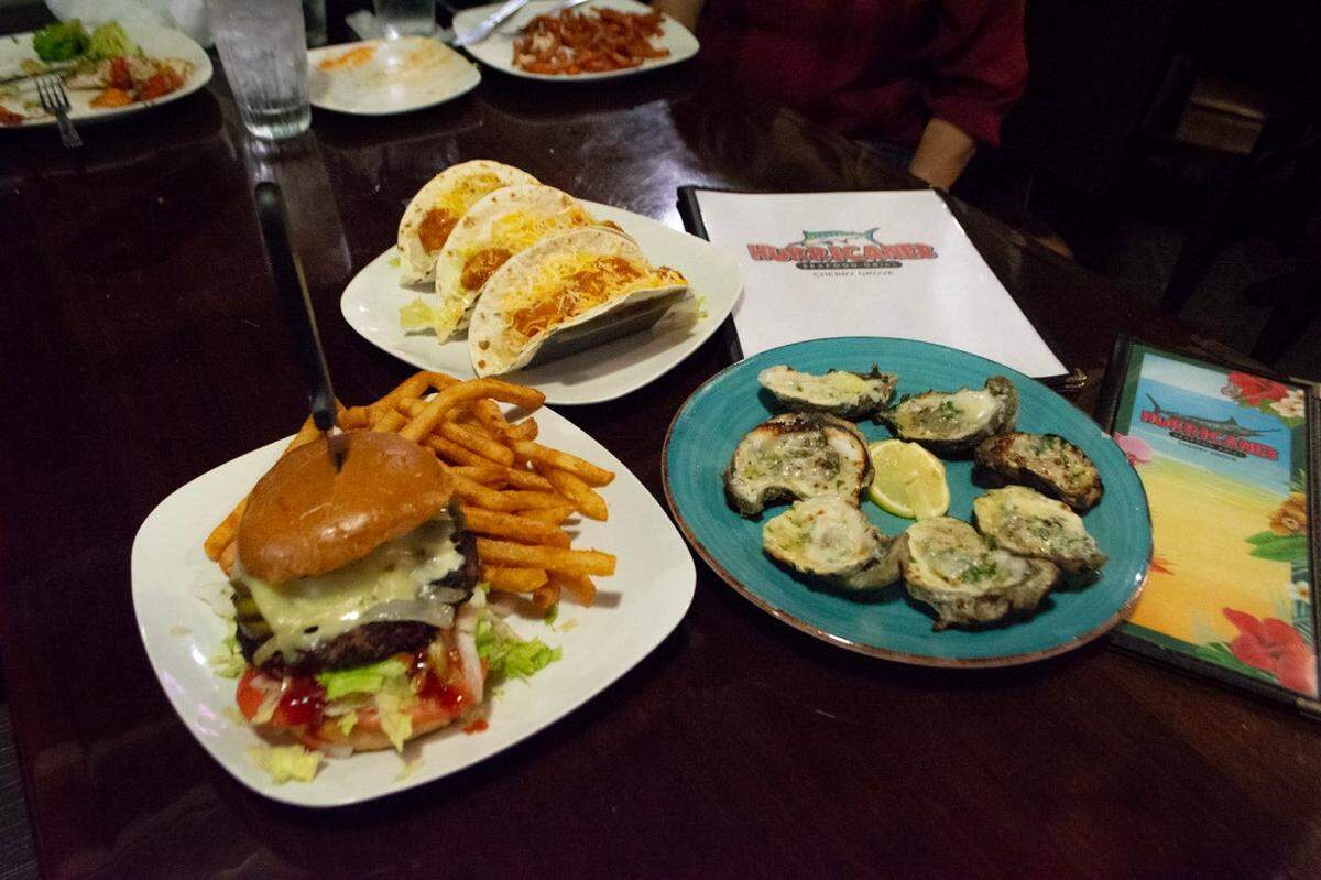 A tri-blend burger, tacos and char-grilled oysters at Hurricanes Seafood Grill on Sea Mountain Highway in North Myrtle Beach.