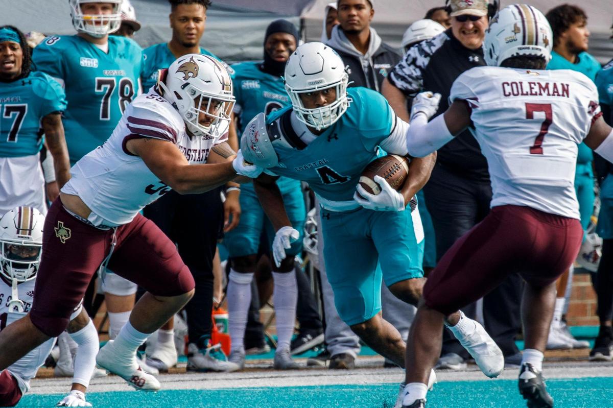 Coastal’s Isaiah Likely threads his way between Texas State defenders on Saturday. Coastal Carolina played Texas State in college football. The Coastal Carolina Chanticleers played the Texas State Bobcats in a Sun Belt Conference NCAA FBS college football game in Conway SC. Nov. 20, 2021.