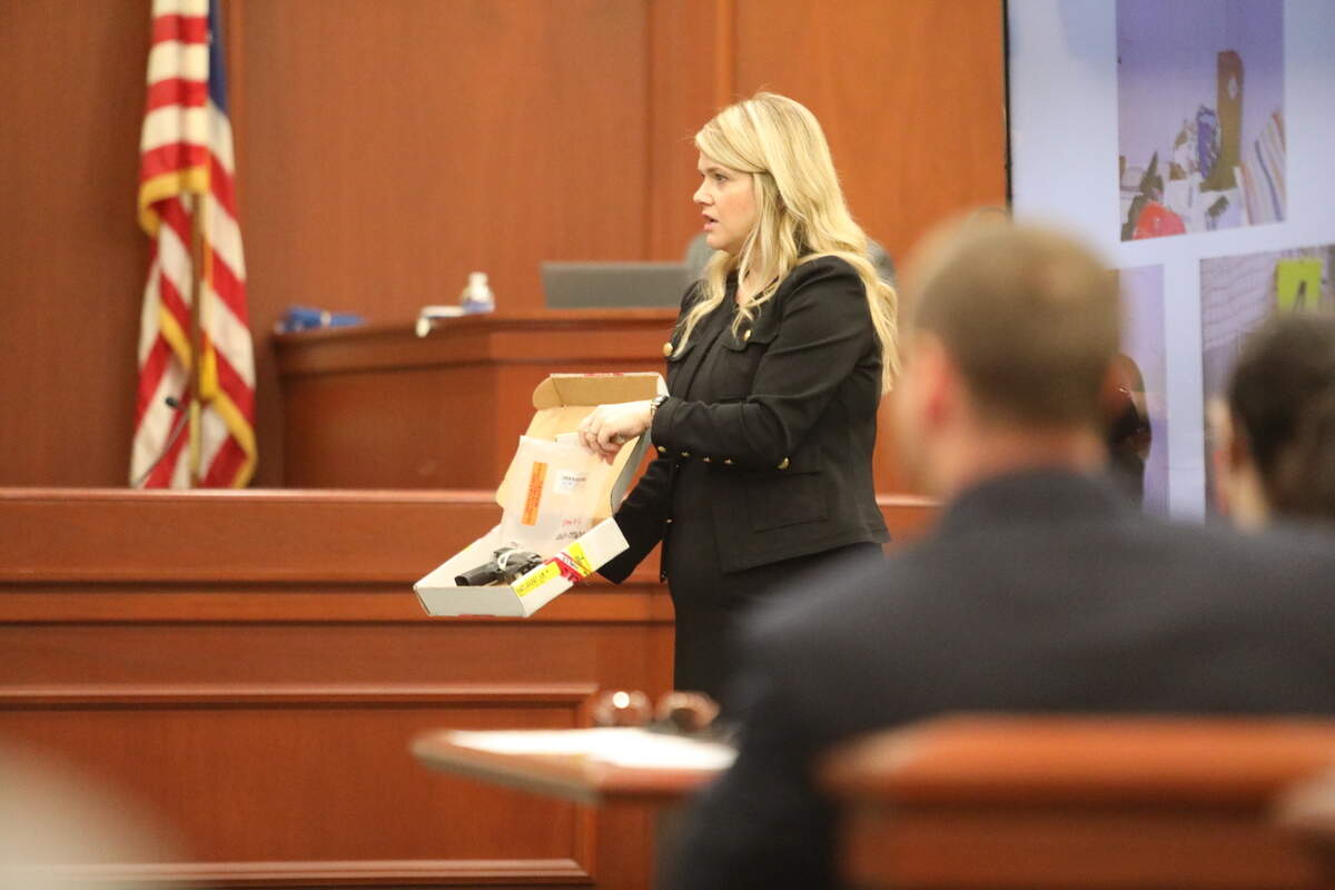 Senior Assistant Solicitor Leigh Andrew Waller presents the murder weapon, a Taurus 9mm handgun, used to kill 20 year-old David Roldan-Dimas to the jury on June 5, 2025.