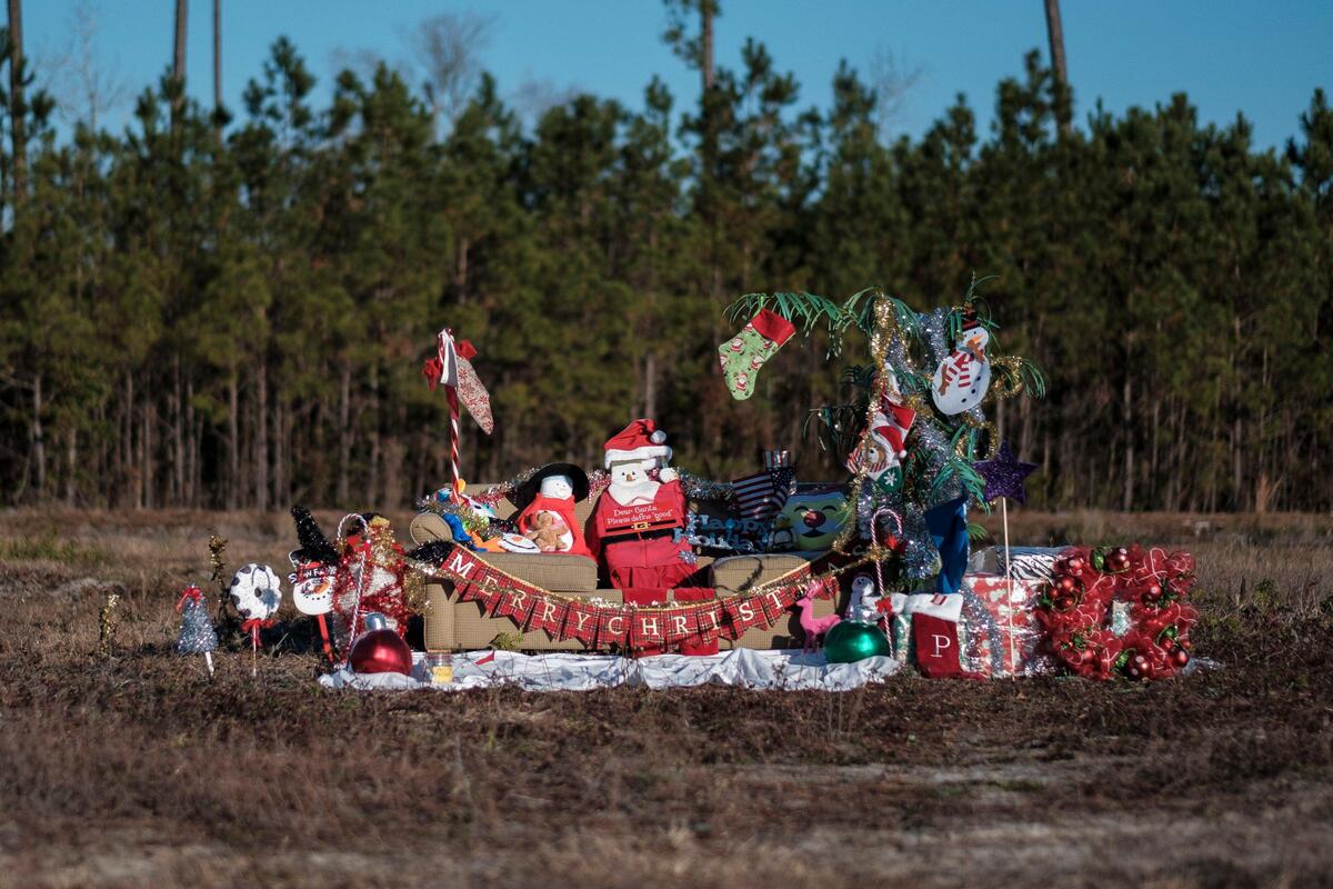 A holiday display featuring Santa on a couch has continued to grow daily since it first showed up in a field off Highway 90 in Little River. The origins of the display remain a mystery.
