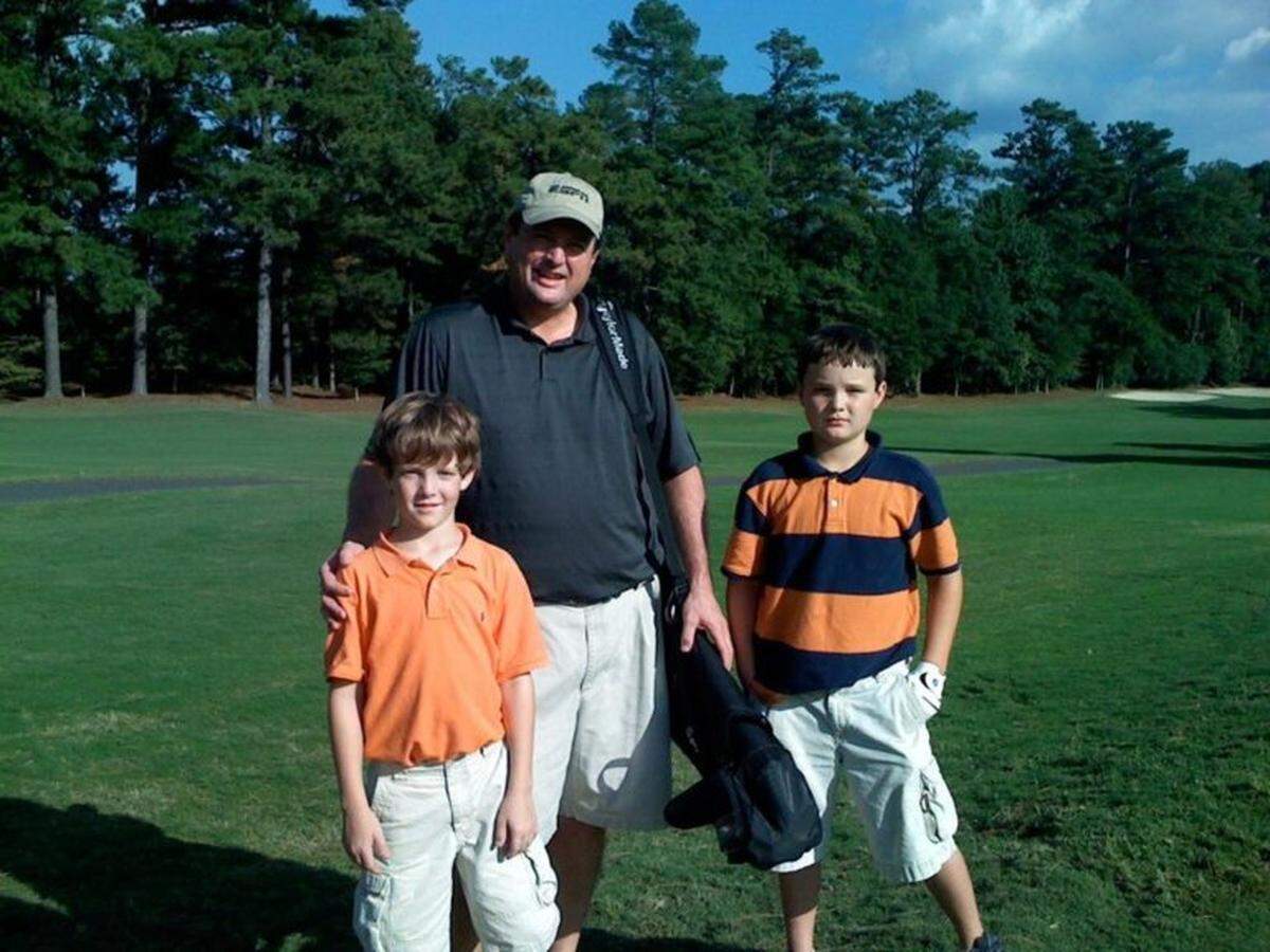 Charlie Rymer with his sons, who are now 22 and 21 years old.