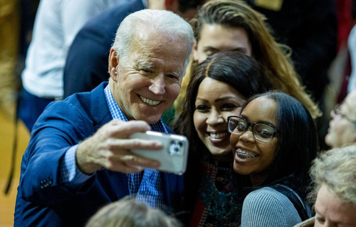 Former U.S. Vice President and 2020 U.S. Democratic presidential candidate Joe Biden takes selfies with supporters after speaking at a town hall at Coastal Carolina University in Conway Thursday evening.