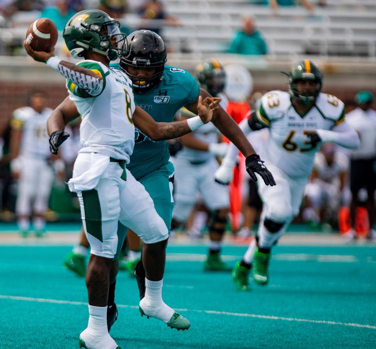 Coastal Carolina senior defensive tackle Sterling Johnson closes in on Norfolk State junior quarterback Juwan Carter on Saturday afternoon during the Chanticleers’ 46-7 win at Brooks Stadium in Conway.