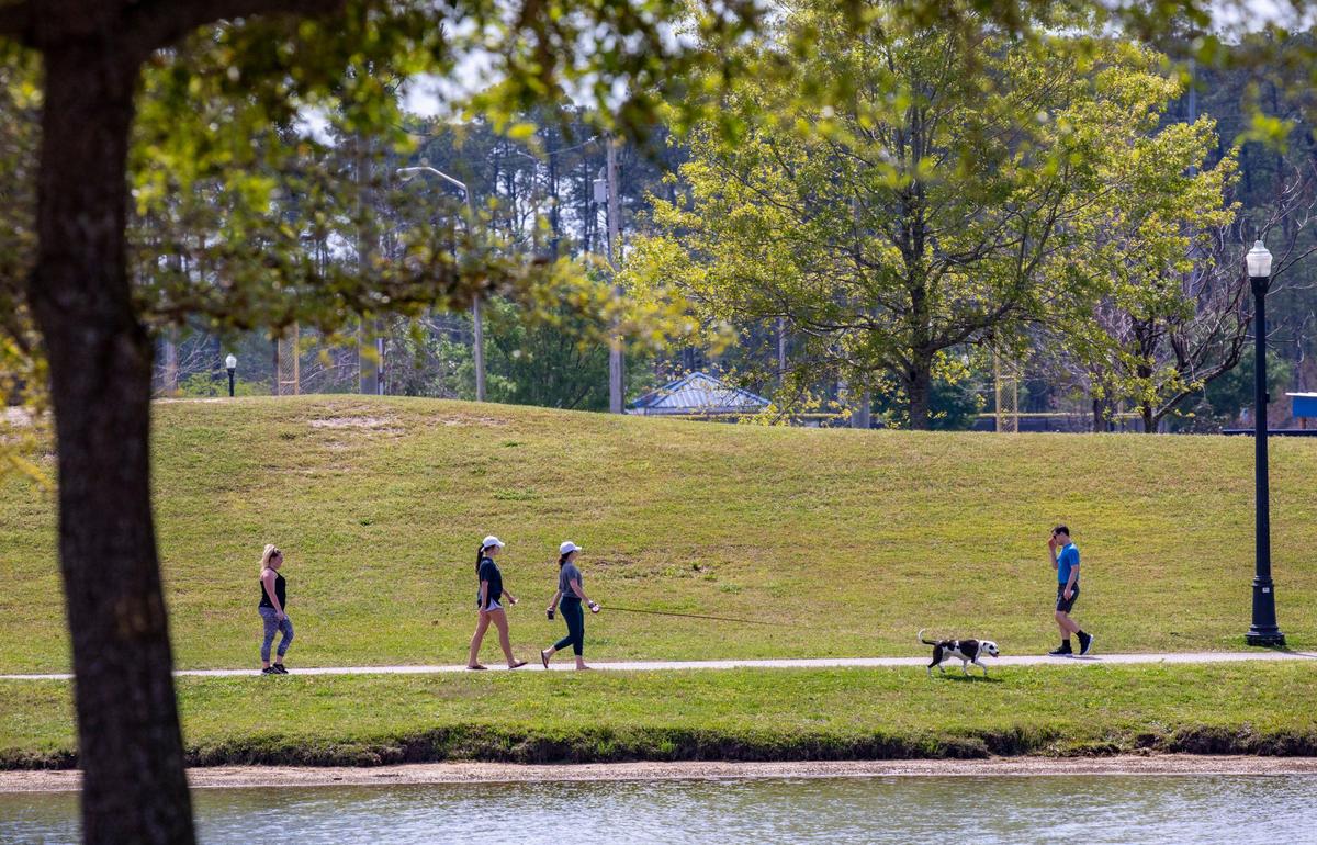 Walkers stroll around the Grand Lake at Market Common on Tuesday. Locals around the Grand Strand were enjoying the Spring weather on Tuesday by getting outside. South Carolina’s Governor Henry McMaster toughed his “work or stay home” order this week In response to the coronavirus, but he made allowances for recreational activities. April 7, 2020
