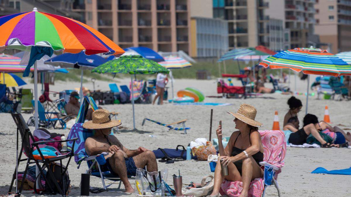 Crowds under bright umbrellas pack North Myrtle Beach on May 31, 2022.