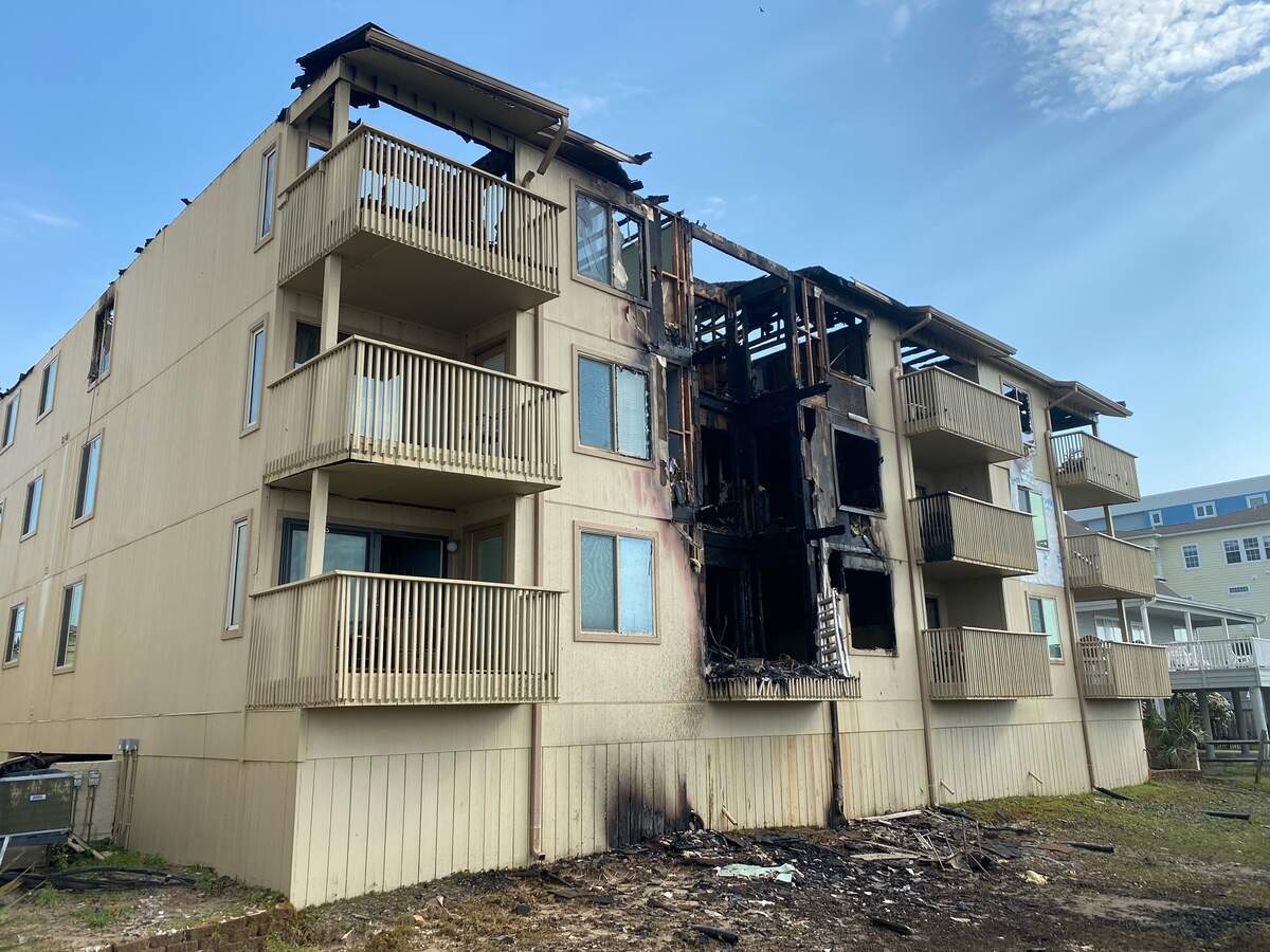 The Coastal Dunes apartment complex after a fire burned through the building and roof early Tuesday morning.