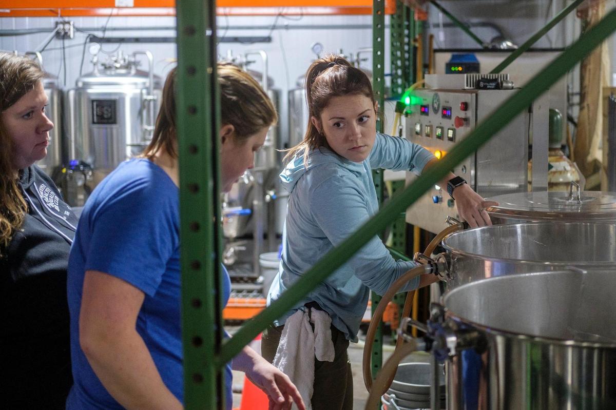Female brewers and bartenders work brewing a Hazy Pale Ale called “Brave Noise.” on Tuesday, Dec. 21, 2021. The collaborative brew is a national movement to end sexism and discrimination in the brewing industry.