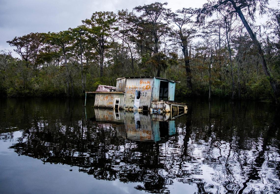 An abandoned houseboat near Bucksport is beginning to fall apart. Abandoned boats litter the waterways throughout Horry County, S.C. The Department of Natural Resources is partnering non-profit conservation groups and local businesses to begin removing the derelict vessels from local waterways. Oct. 6, 2021.