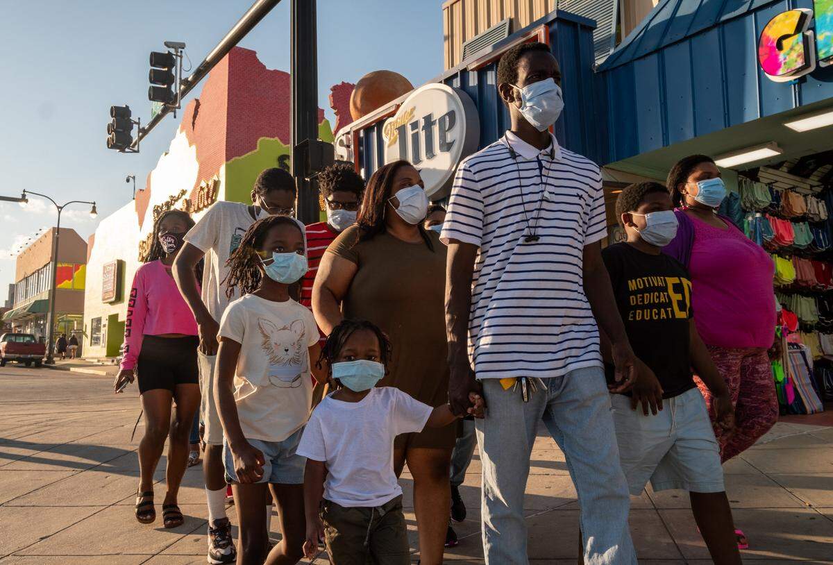 The King family with members from North Carolina and Pennsylvania, carefully make their way up Ocean Boulevard wearing masks with some members saying it was scary to be out during the coronavirus but agreeing that they needed a dose of freedom. Though barricades were in place, this Saturday of Memorial Day weekend looked much different from years past. With the traditional Atlantic Beach Bikefest postponed, few bikers made the the trip to Myrtle Beach but family groups, some wearing masks walked Ocean Boulevard. Myrtle Beach, S.C. May 23, 2020