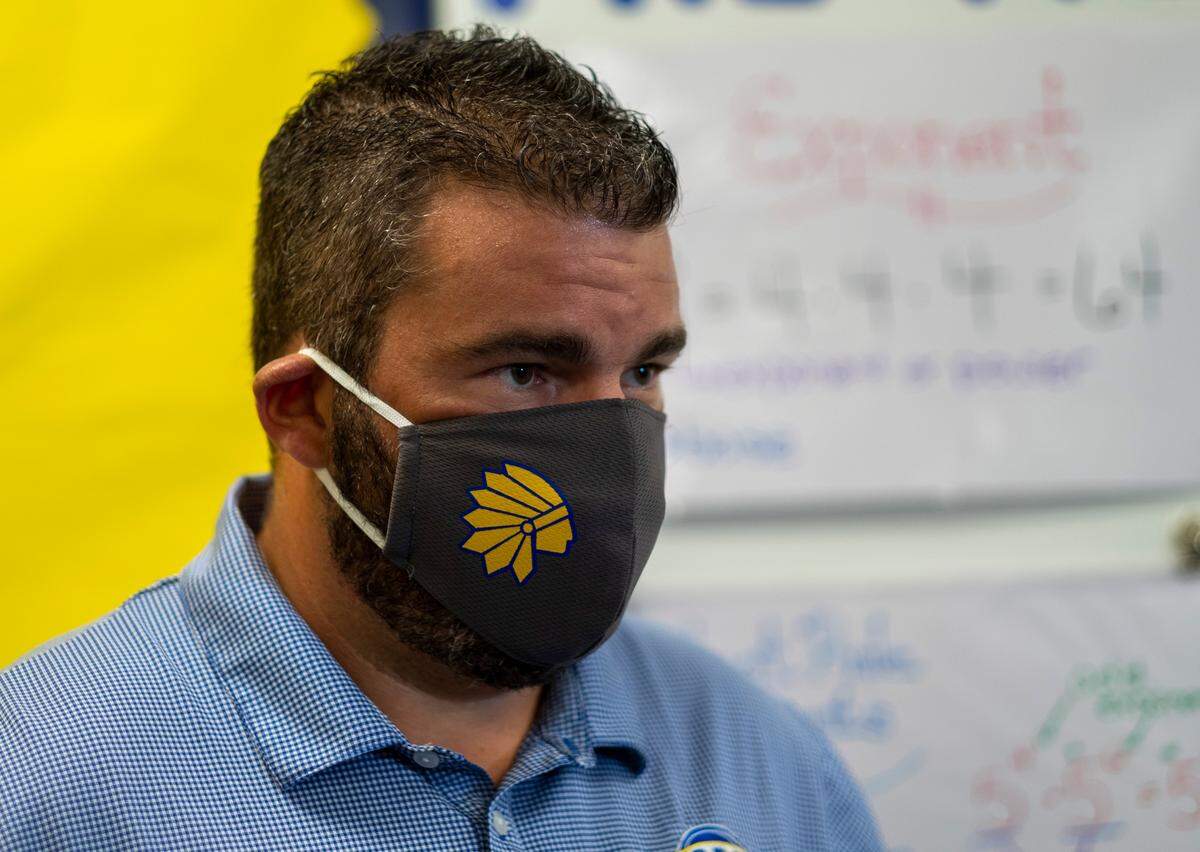 Wearing a mask with the North Myrtle Beach Middle School logo, Principal James LaPier talks to the media on Thursday. Teachers returned to North Myrtle Beach Middle School on Thursday and are preparing for the eventual re-opening after having been closed due to the coronavirus threat. August 27, 2020