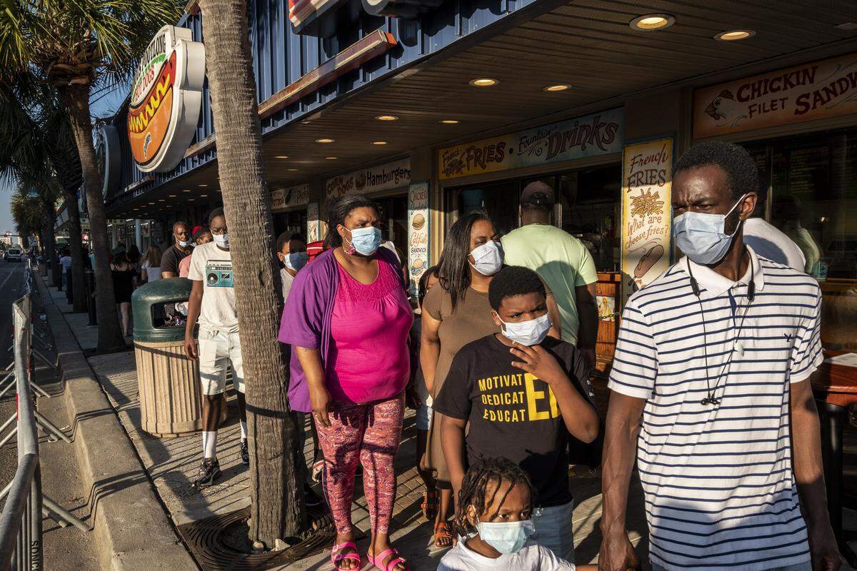 The King family with members from North Carolina and Pennsylvania, carefully make their way up Ocean Boulevard wearing masks with some members saying it was scary to be out during the coronavirus but agreeing that they needed a dose of freedom. Though barricades were in place, this Saturday of Memorial Day weekend looked much different from years past. With Bike Fest postponed, family groups, some wearing masks walked Ocean Boulevard. May 23, 2020