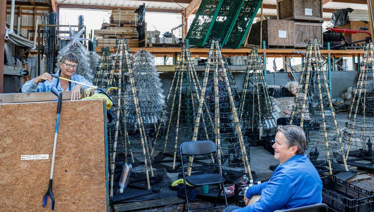 Diane Bevins, left, and Sandra Zanfini, right, organize and clean plastic bottles to use as decorations. Workers and volunteers are busily preparing Brookgreen Gardens in Murrells Inlet, S.C. for the Night of a Thousand Candles event starting November 30, 2024. Oct. 31, 2024.