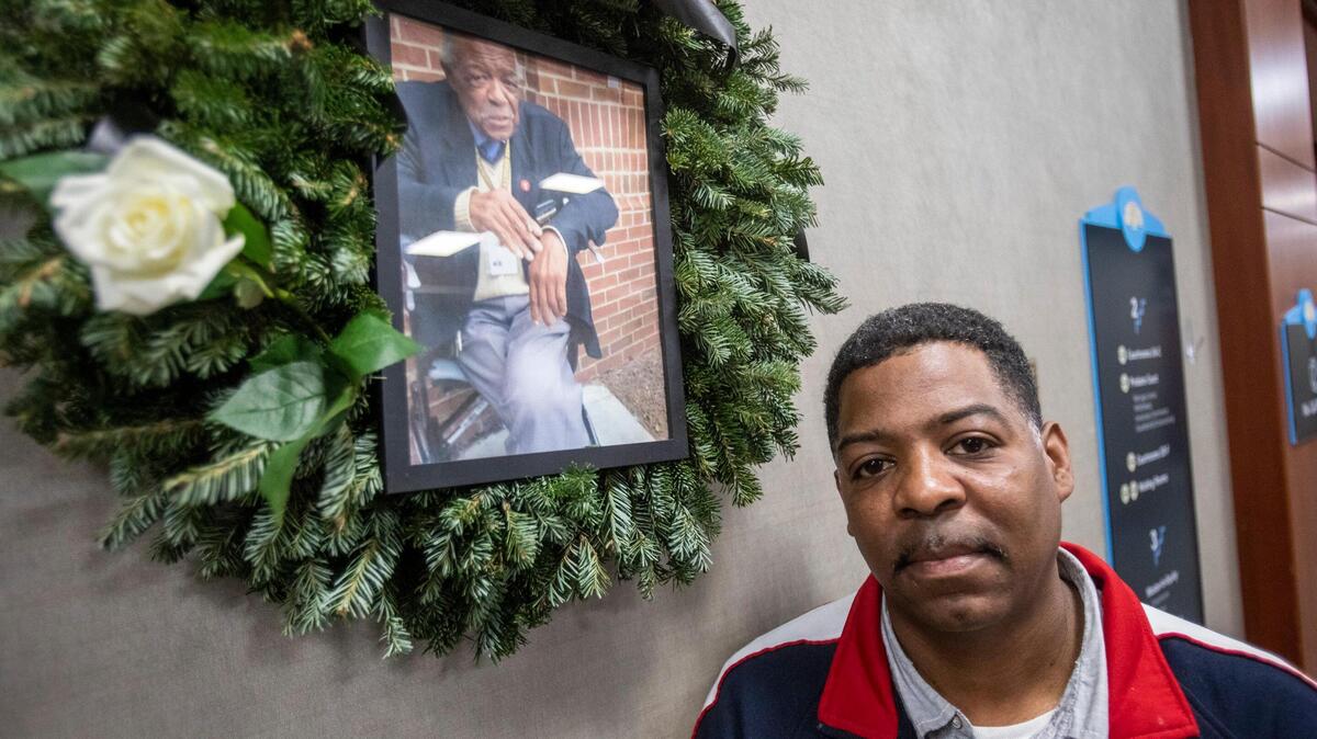 James Earl Spain II, paid a visit to his father’s memorial in the Horry County courthouse on Monday. Earl Spain, “Mr. Earl” to many in the courthouse, began working for the Horry County Sheriff’s office on the second floor in 2002. A wreath with his picture was placed above the desk where he worked and served as a gathering place on Monday for deputies to share remembrances with his son.