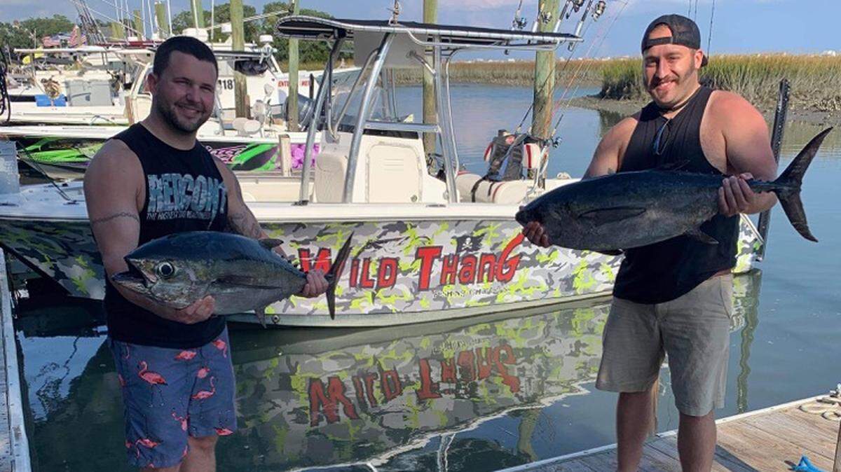 Part of the crew aboard Murrells Inlet Fishing Center’s Wild Thang shows off a pair of blackfin tuna caught from the Belky Bear vicinity last Saturday.