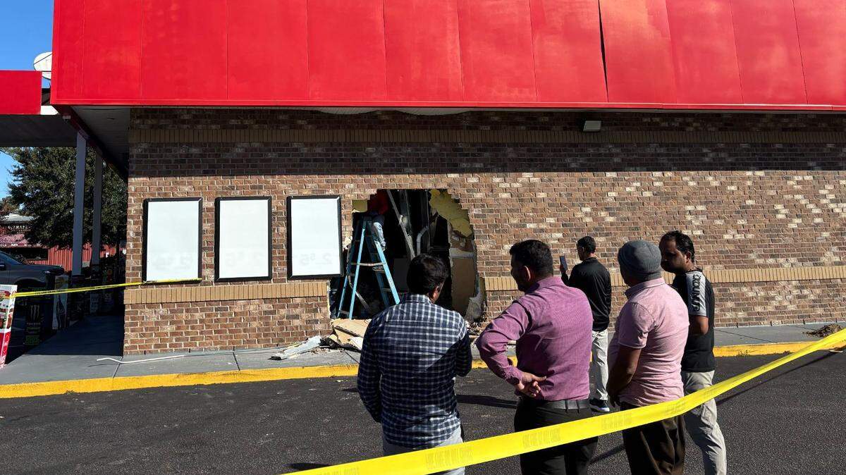 Owners of Coastal Petro stand around the building assessing damage. A car ran into the side of the building early Monday morning.